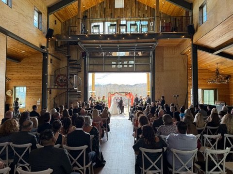 Timber-frame barn interior set up for a wedding