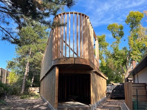 Curved wall framing under construction, studs bent to shape