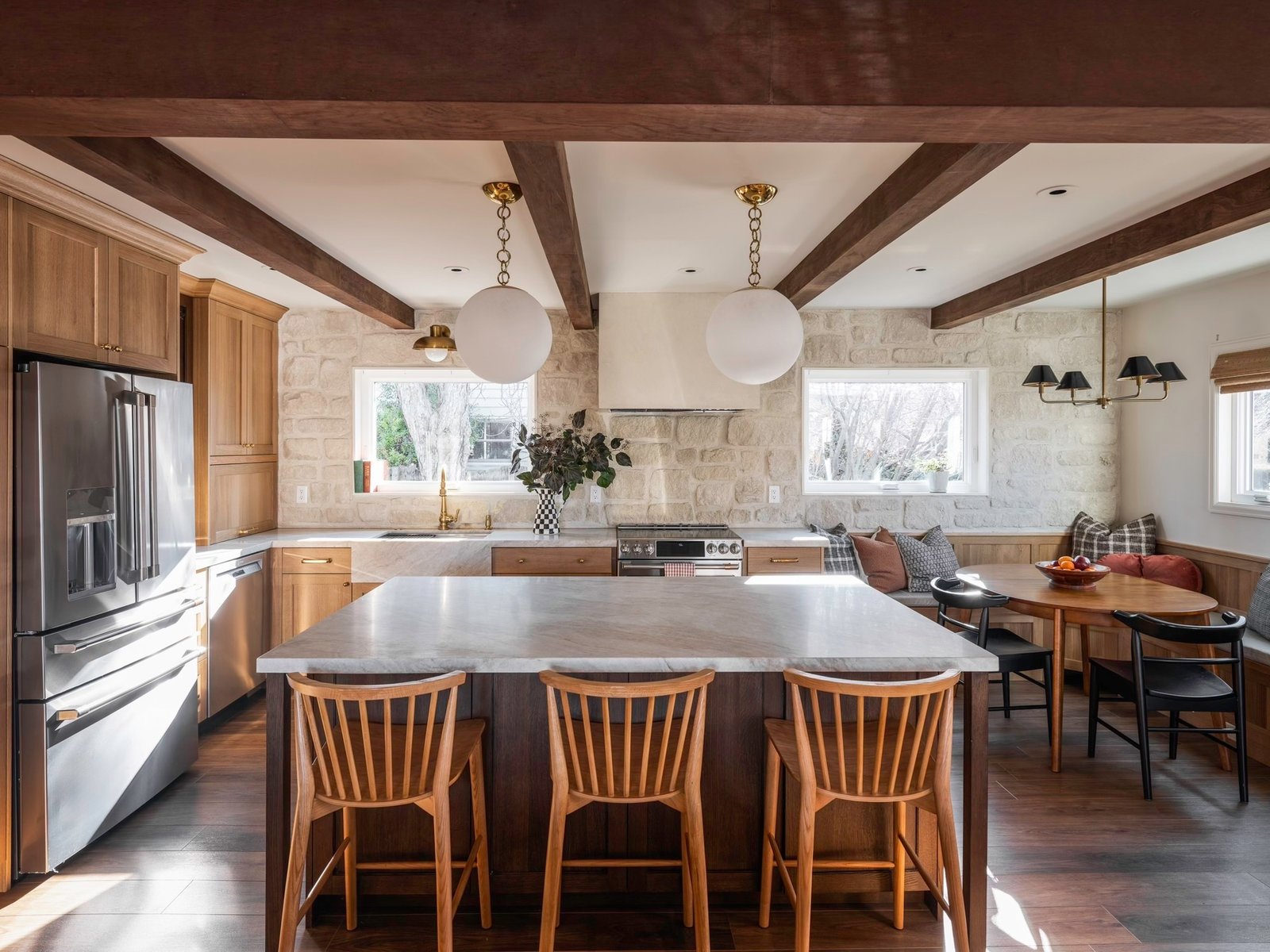 Custom kitchen with hand-laid stone wall and walnut island